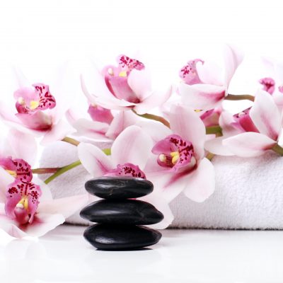 Spa stones and beautiful orchid over white background